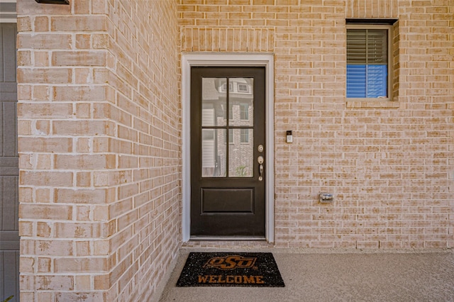 property entrance with brick siding