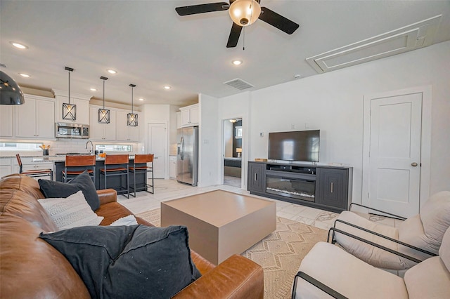 living room with recessed lighting, visible vents, marble finish floor, and a ceiling fan