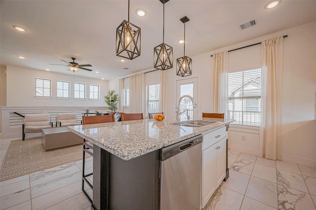 kitchen featuring visible vents, marble finish floor, a sink, plenty of natural light, and dishwasher