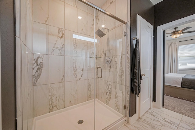 full bath featuring ceiling fan, connected bathroom, marble finish floor, and a stall shower