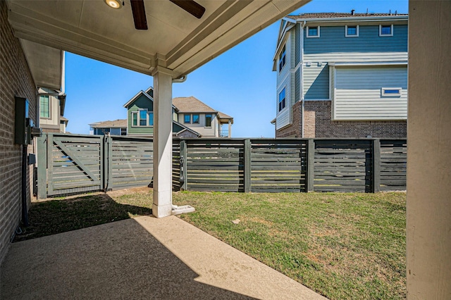 view of yard featuring a patio area, a ceiling fan, and a fenced backyard