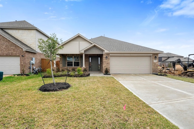 view of front of house featuring a garage, concrete driveway, roof with shingles, a front yard, and brick siding