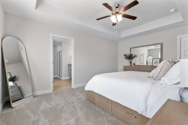 13540 Diamond Reef Ln, Texas City, TX 77568 - bedroom with ceiling fan, ensuite bathroom, light colored carpet, baseboards, and a tray ceiling