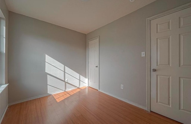 interior space with wood finished floors and baseboards
