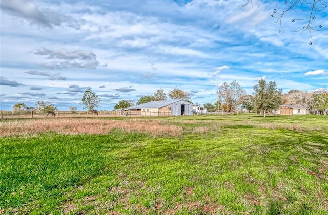 view of yard featuring an outbuilding and a rural view