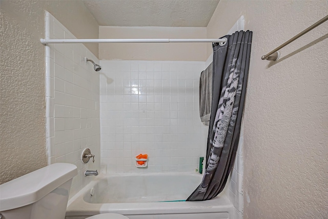 bathroom with a textured ceiling, a textured wall, toilet, and shower / tub combo with curtain