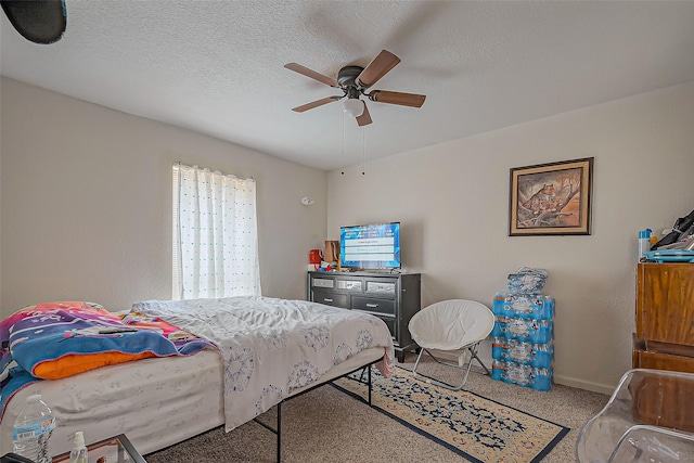 carpeted bedroom with baseboards, a ceiling fan, and a textured ceiling