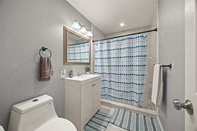 bathroom featuring curtained shower, vanity, and toilet