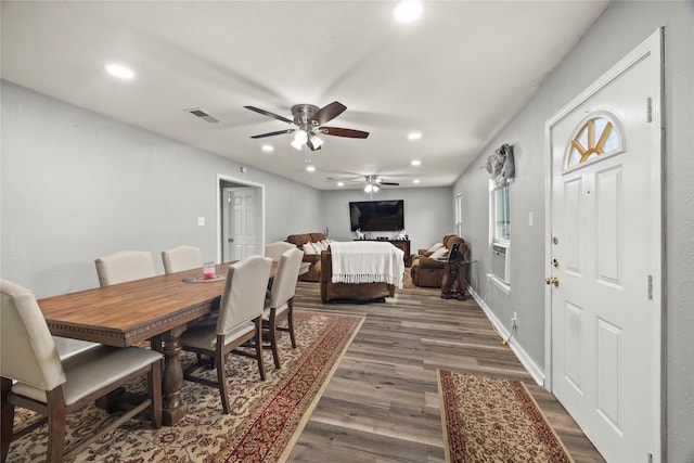 dining area with dark wood-type flooring, recessed lighting, visible vents, and baseboards