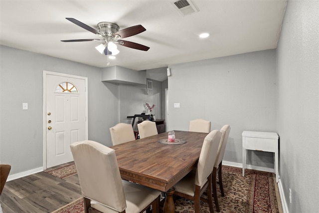 dining space featuring ceiling fan, wood finished floors, visible vents, and baseboards