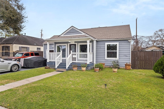 bungalow-style house with covered porch, a front lawn, and fence