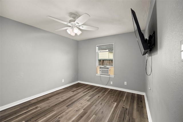 spare room featuring cooling unit, wood finished floors, a ceiling fan, and baseboards