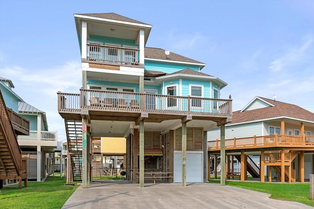 view of front of home featuring stairs, a carport, a front lawn, and concrete driveway