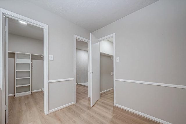 interior space featuring light wood-style flooring and baseboards