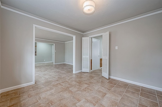 unfurnished room with baseboards and crown molding