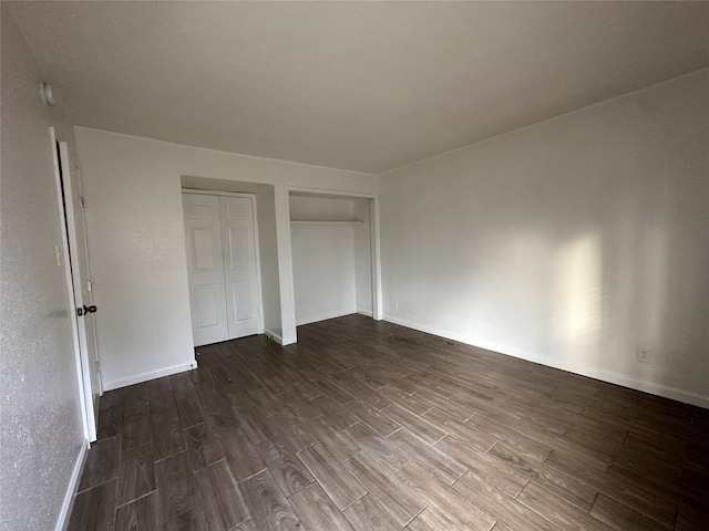 unfurnished bedroom with baseboards and wood finished floors