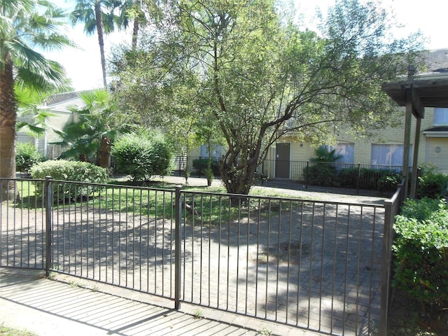 view of gate with a fenced front yard