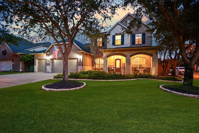 traditional home with a garage, a front yard, a porch, and brick siding