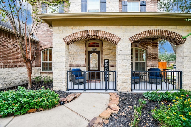 doorway to property featuring stone siding and brick siding