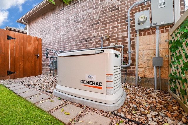 exterior details with gas meter, fence, electric meter, a power unit, and brick siding