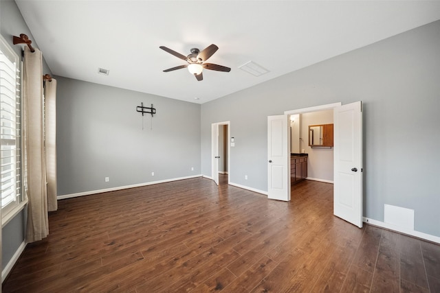 unfurnished bedroom featuring visible vents, baseboards, dark wood finished floors, and a ceiling fan