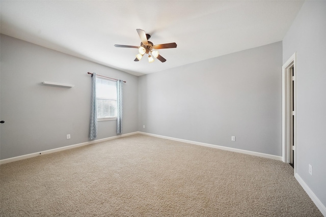 empty room with a ceiling fan, light colored carpet, and baseboards