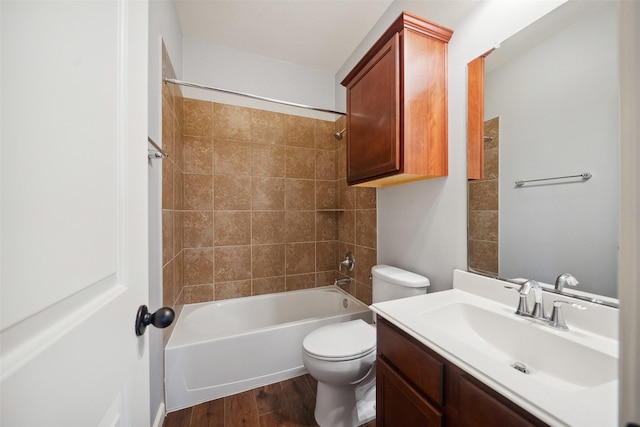 bathroom featuring shower / washtub combination, vanity, toilet, and wood finished floors