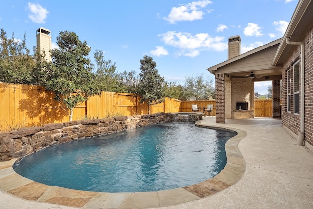 view of pool featuring exterior fireplace, a fenced backyard, a ceiling fan, a fenced in pool, and a patio area