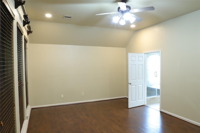 interior space featuring lofted ceiling, visible vents, a ceiling fan, wood finished floors, and baseboards