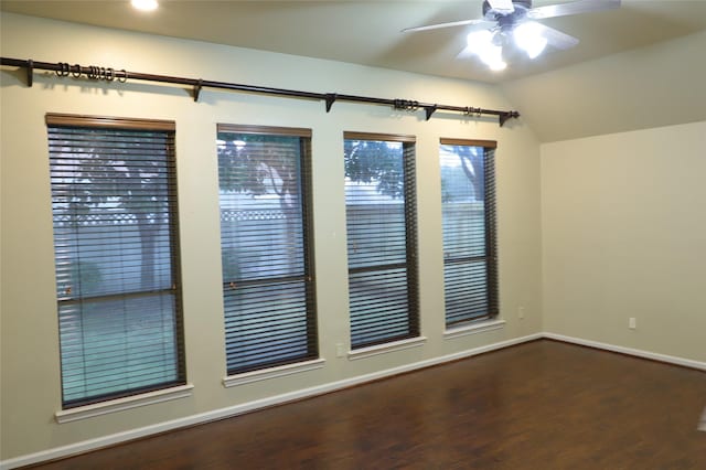 spare room with lofted ceiling, ceiling fan, baseboards, and wood finished floors