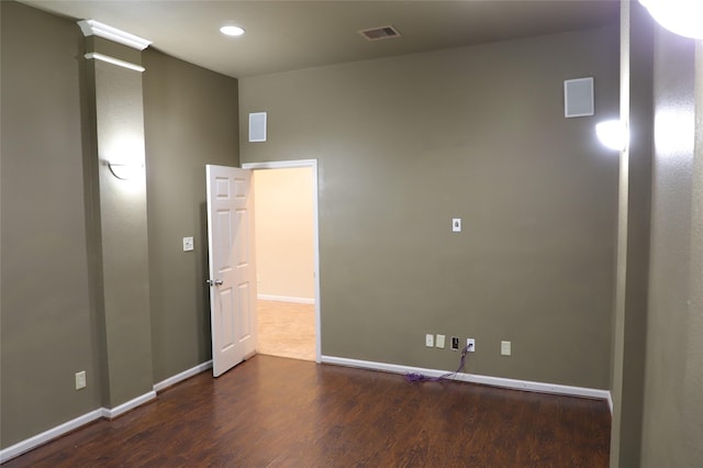 spare room with recessed lighting, wood finished floors, visible vents, baseboards, and ornate columns