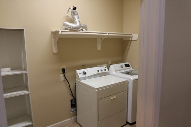 laundry area with laundry area, baseboards, and washer and dryer