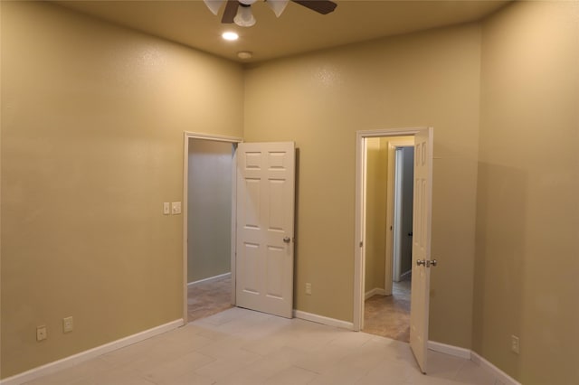 empty room with baseboards and a ceiling fan