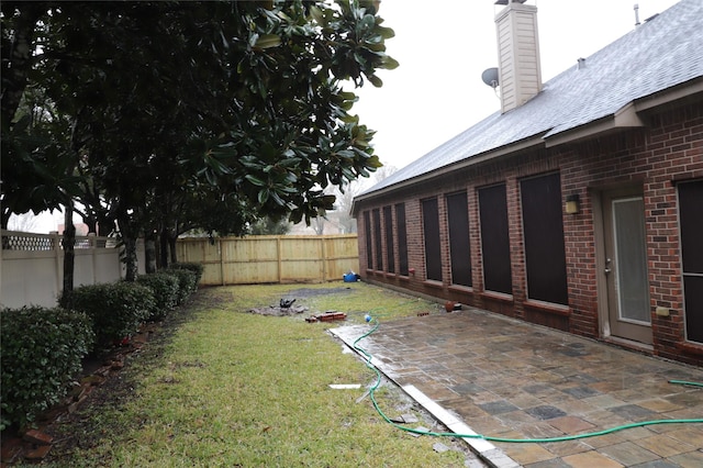 view of yard with a patio area and a fenced backyard