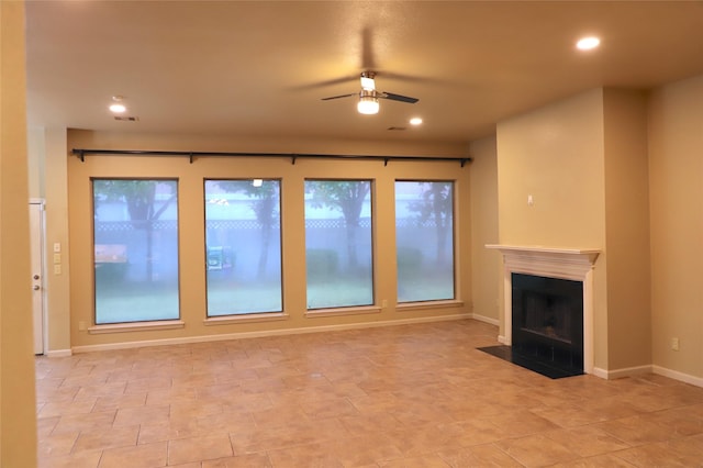 unfurnished living room with a fireplace with flush hearth, baseboards, a ceiling fan, and recessed lighting