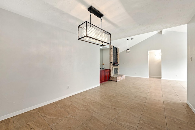 interior space featuring lofted ceiling and baseboards