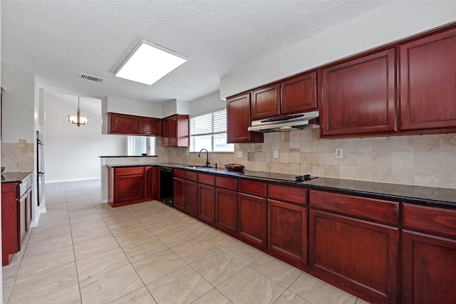 kitchen featuring reddish brown cabinets, visible vents, a peninsula, under cabinet range hood, and a sink