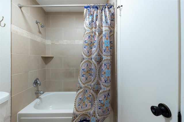 bathroom featuring toilet and shower / tub combo with curtain