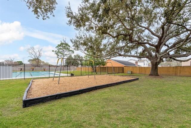 community play area featuring a lawn, a fenced backyard, and a fenced in pool