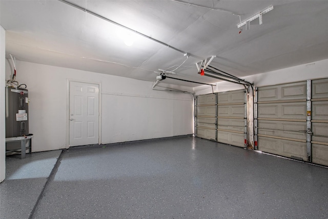 garage with a garage door opener and electric water heater