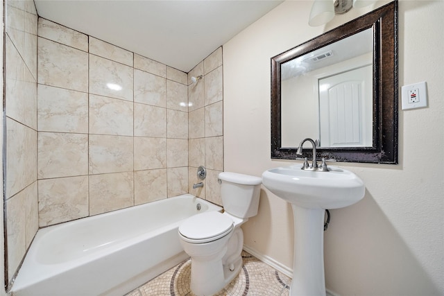 bathroom with washtub / shower combination, visible vents, a sink, and toilet