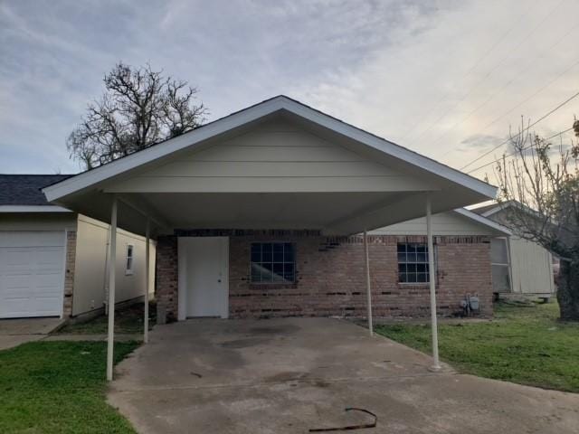 view of front of property with an attached carport and brick siding