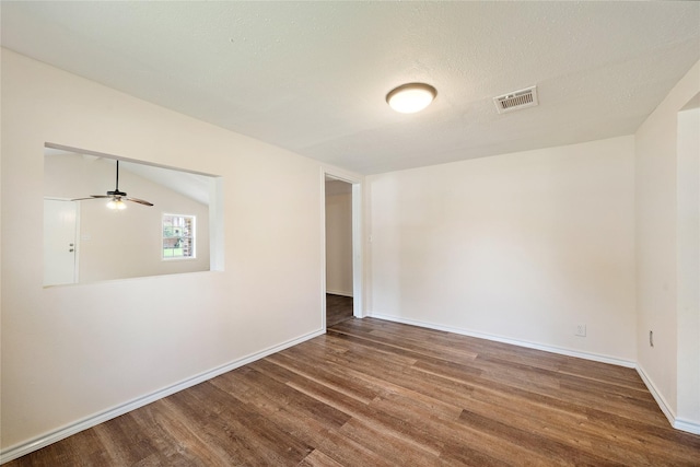 unfurnished room with a ceiling fan, baseboards, visible vents, and wood finished floors