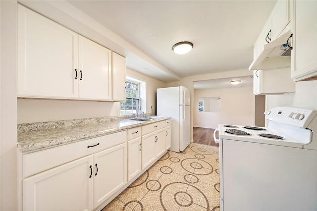 kitchen featuring white appliances, light tile patterned floors, white cabinets, under cabinet range hood, and a sink