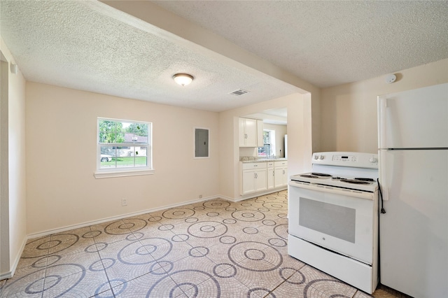 kitchen featuring white appliances, electric panel, visible vents, white cabinets, and light countertops