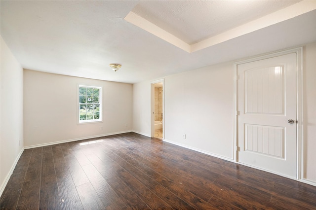 unfurnished room featuring dark wood-style floors and baseboards