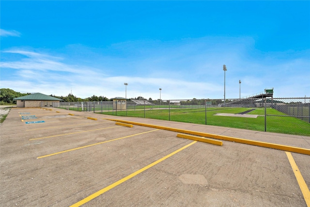 uncovered parking lot featuring fence