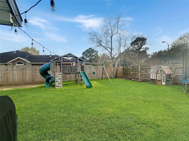 view of yard with a playground and a fenced backyard