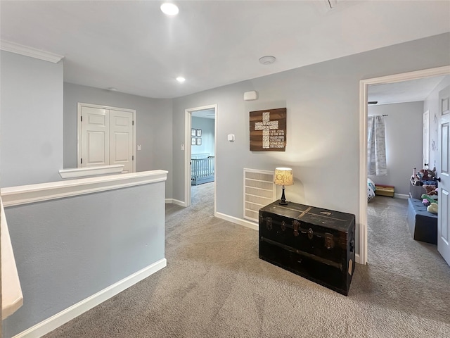 hallway with visible vents, baseboards, carpet, an upstairs landing, and recessed lighting