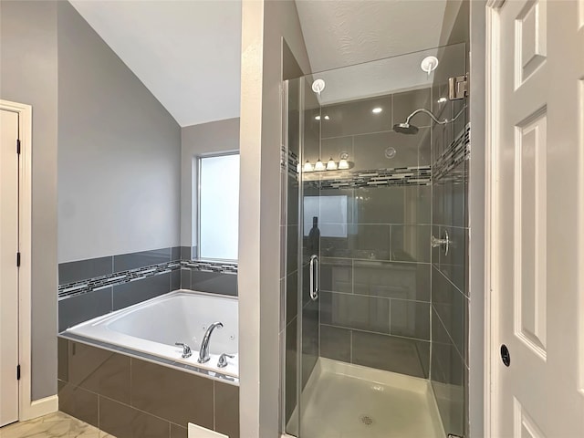 full bathroom featuring a shower stall, a bath, and lofted ceiling